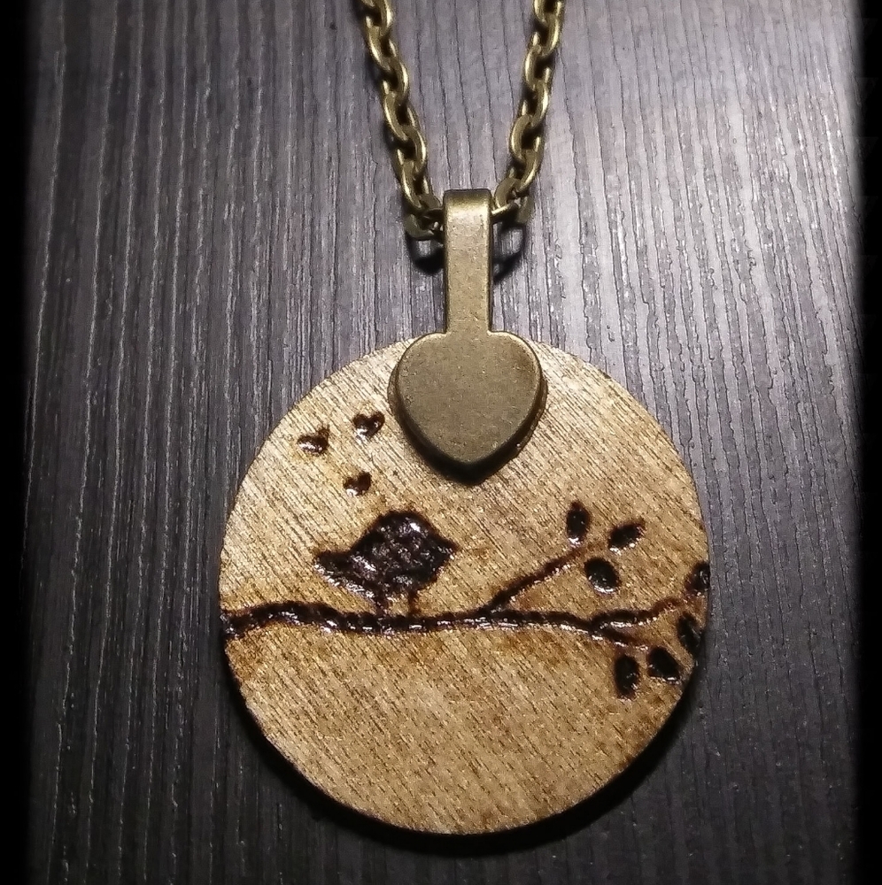 Hand crafted wood pendant with woodburned birdie
